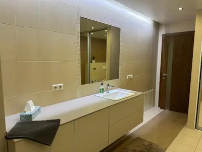 a bathroom with a sink and a mirror at Apartamentai in Marijampolė