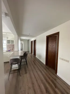 a kitchen and dining room with a table and chairs at Apartamentai in Marijampolė