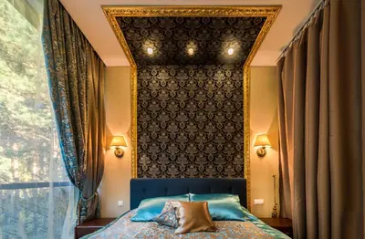 a bedroom with a blue bed and a window at Baltazaras in Vilnius