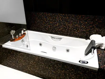 a bathroom with a white sink on a wall at Baltazaras in Vilnius