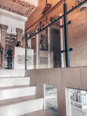 a person sitting on a counter in front of a mirror at Baltazaras in Vilnius