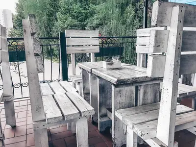 a group of wooden benches sitting next to a fence at Baltazaras in Vilnius