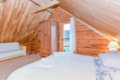 a bedroom with a bed and a window in a cabin at Aerodream Trakai in Antakalnis