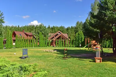 a park with a log cabin and a playground at Aerodream Trakai in Antakalnis