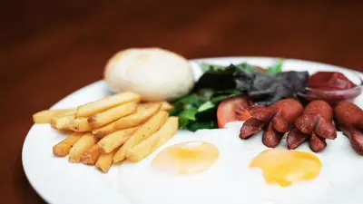 a plate of food with eggs and french fries at Aerodream Trakai in Antakalnis