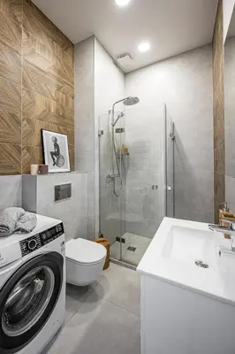 a bathroom with a washing machine and a sink at Bali style apartment with balcony near Gates of Dawn in Vilnius