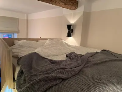 a bed with a blanket on it in a room at CLASSY PLACE IN VILNIUS CENTER FOR TWO in Vilnius
