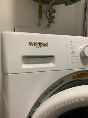 a white washing machine with the words whirlpool on it at CLASSY PLACE IN VILNIUS CENTER FOR TWO in Vilnius