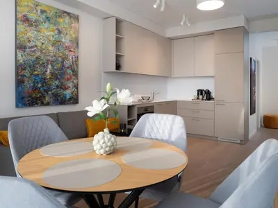 a kitchen and dining room with a table and chairs at Butique Apartamentai Birštone - Holistic Skin & Wellness SPA Apartments - Inovatyvios dermatologijos centras in Birštonas