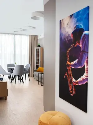 a room with a picture of a man playing a saxophone at Butique Apartamentai Birštone - Holistic Skin & Wellness SPA Apartments - Inovatyvios dermatologijos centras in Birštonas