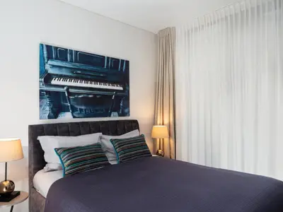 a bedroom with a bed with a piano on the wall at Butique Apartamentai Birštone - Holistic Skin & Wellness SPA Apartments - Inovatyvios dermatologijos centras in Birštonas