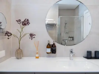a bathroom with a sink and a mirror at Butique Apartamentai Birštone - Holistic Skin & Wellness SPA Apartments - Inovatyvios dermatologijos centras in Birštonas