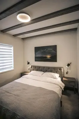 a bedroom with a large bed and a window at Senamiesčio apartamentai in Anykščiai