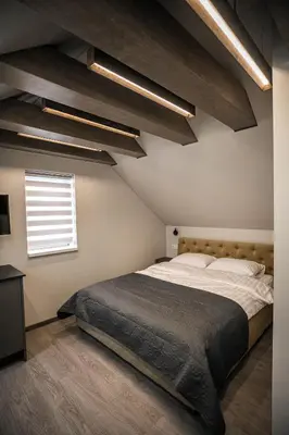 a bedroom with a large bed and a window at Senamiesčio apartamentai in Anykščiai