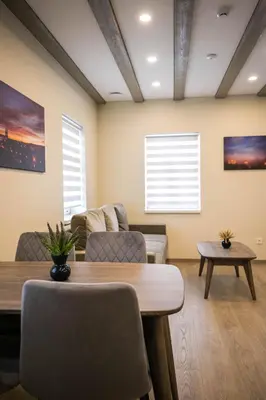 a living room with a table and a couch at Senamiesčio apartamentai in Anykščiai