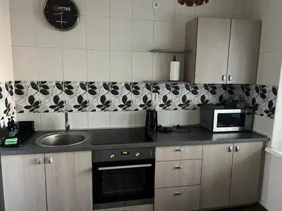 a kitchen with a sink and a microwave at 2 kambarių butas Alytuje in Alytus