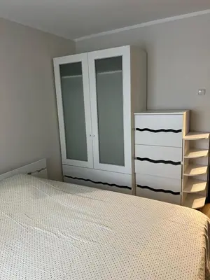 a bedroom with a bed and a dresser at 2 kambarių butas Alytuje in Alytus