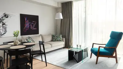 a living room with a couch and a table at Butique Apartamentai Birštone - Holistic Skin & Wellness SPA Apartments - Inovatyvios dermatologijos centras in Birštonas