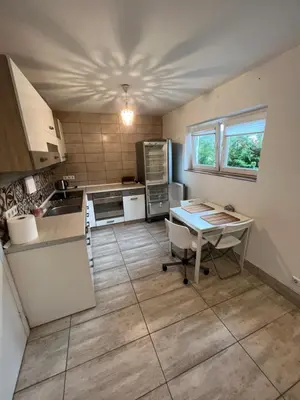 a kitchen with a desk and a table in it at HELLO House in Alytus