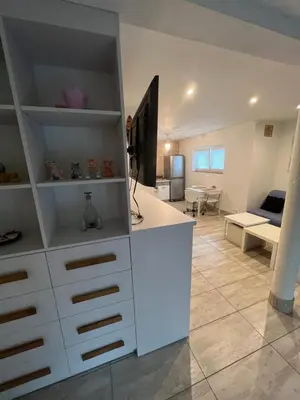 a living room with a white counter and a couch at HELLO House in Alytus