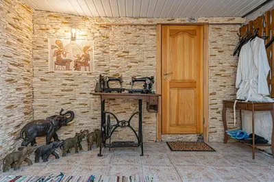 a room with a wooden table and animals on the wall at Spacious Studio apartment by Polo apartments in Kaunas