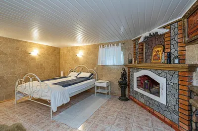 a bedroom with a bed and a fireplace at Spacious Studio apartment by Polo apartments in Kaunas