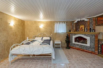 a bedroom with a bed and a fireplace at Spacious Studio apartment by Polo apartments in Kaunas