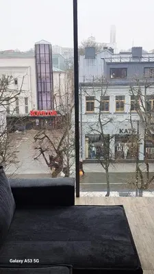 a living room with a couch in front of a window at KaunasInn LA in Kaunas