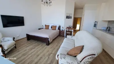 a living room with a couch and a bed at KaunasInn LA in Kaunas