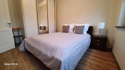 a bedroom with a large bed with white sheets and pillows at KaunasInn LA in Kaunas
