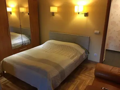 a bedroom with a bed and a large mirror at Butas su Jacuzzi in Kaunas