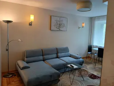 a living room with a couch and a table at Butas su Jacuzzi in Kaunas