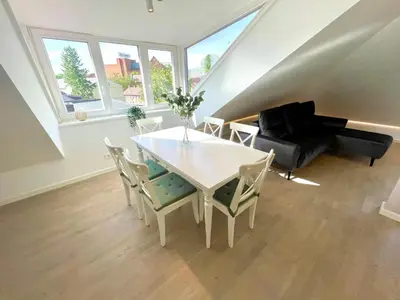 a dining room with a table and chairs and a couch at Luxury Central Apartment Easy Kaunas in Kaunas