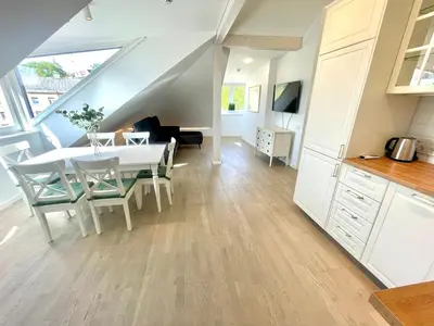 a kitchen and dining room with a table and chairs at Luxury Central Apartment Easy Kaunas in Kaunas