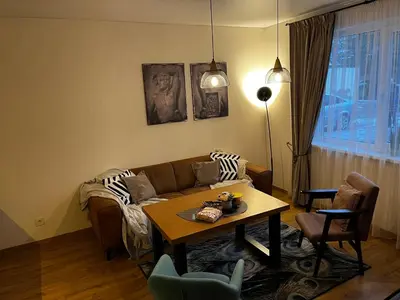 a living room with a couch and a table at Kauno Senamiestis in Kaunas