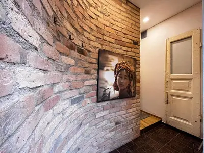 a television hanging on a brick wall at Kauno Senamiestis in Kaunas