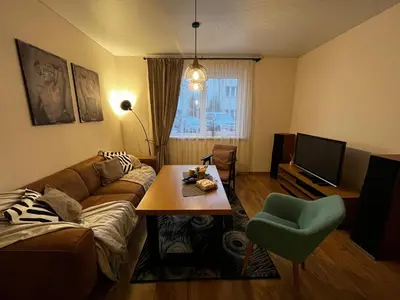 a living room with a couch and a table at Kauno Senamiestis in Kaunas