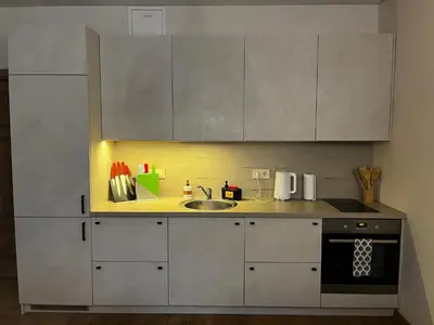 a kitchen with white cabinets and a sink at Kauno Senamiestis in Kaunas