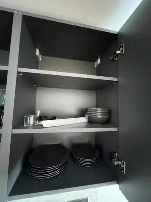a kitchen with plates and bowls on shelves at Hygge Apartments in Druskininkai