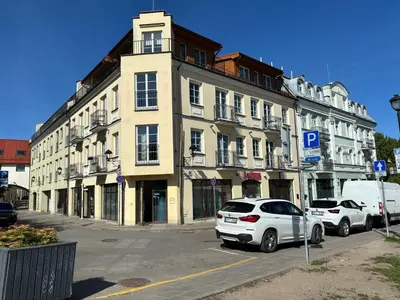 a white car parked in front of a building at Barbacan Apartments in the Old Town in Vilnius