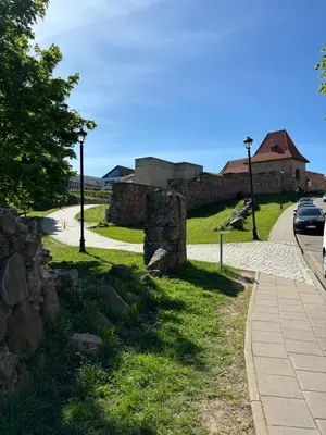 a stone wall on the side of a road at Barbacan Apartments in the Old Town in Vilnius
