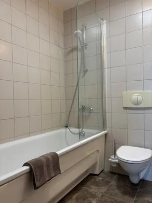 a bathroom with a tub and a toilet and a shower at Barbacan Apartments in the Old Town in Vilnius