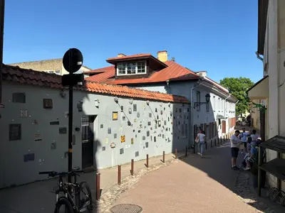 a group of people standing next to a building at Barbacan Apartments in the Old Town in Vilnius