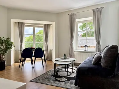 a living room with a couch and a table at Barbacan Apartments in the Old Town in Vilnius