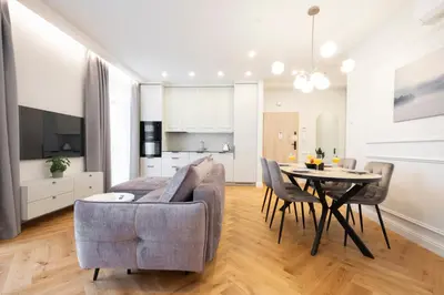 a living room with a couch and a table at 2BD,Terrace, AC, next to Dineika Park, Brand NEW, by Cohost in Druskininkai