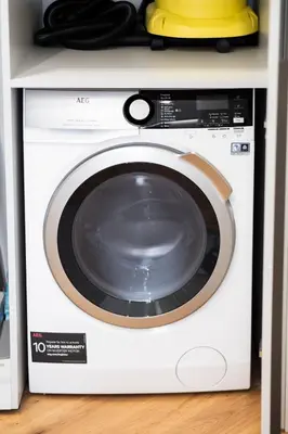 a white washing machine with a yellow hat on top at 2BD,Terrace, AC, next to Dineika Park, Brand NEW, by Cohost in Druskininkai