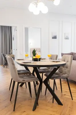 a dining room with a table and chairs at 2BD,Terrace, AC, next to Dineika Park, Brand NEW, by Cohost in Druskininkai