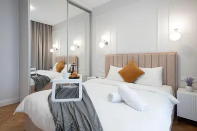 a bedroom with two beds and a mirror at 2BD,Terrace, AC, next to Dineika Park, Brand NEW, by Cohost in Druskininkai