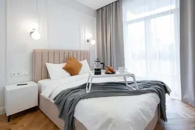 a bedroom with a bed with a table on it at 2BD,Terrace, AC, next to Dineika Park, Brand NEW, by Cohost in Druskininkai