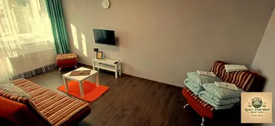 a living room with two couches and a tv at Quiet apartment near park SELF CHECK IN in Šiauliai